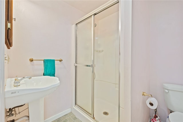 bathroom with toilet and a shower with shower door