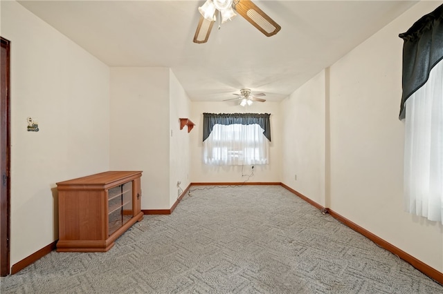 unfurnished room featuring ceiling fan and light carpet