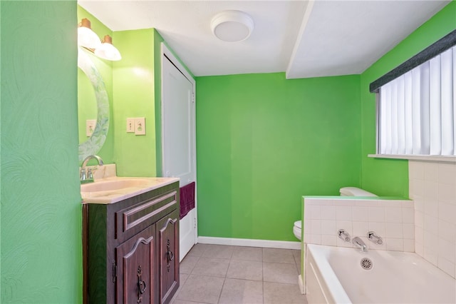 bathroom with toilet, vanity, tile patterned floors, and a bathing tub