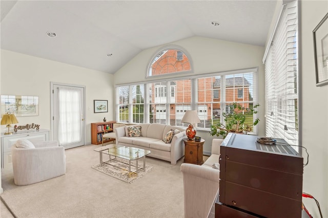 living room featuring light carpet and lofted ceiling