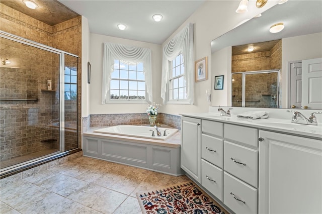 bathroom with vanity and shower with separate bathtub