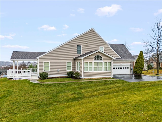 back of property featuring a yard and a garage