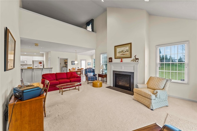 living room with carpet and high vaulted ceiling