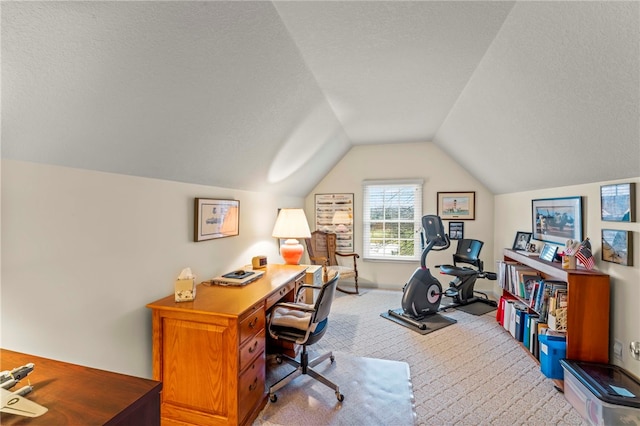 carpeted office space featuring a textured ceiling and lofted ceiling