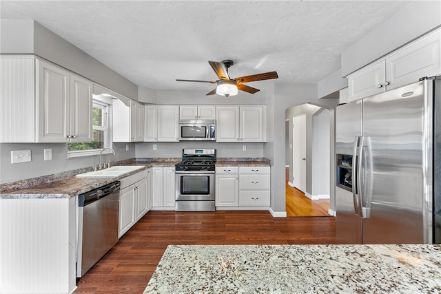 kitchen with white cabinetry, sink, ceiling fan, dark hardwood / wood-style flooring, and appliances with stainless steel finishes