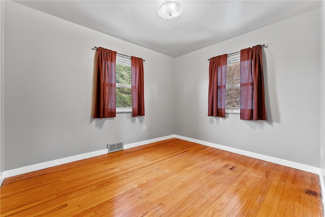 empty room with hardwood / wood-style floors