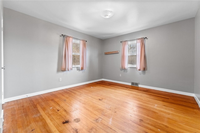 spare room featuring hardwood / wood-style floors