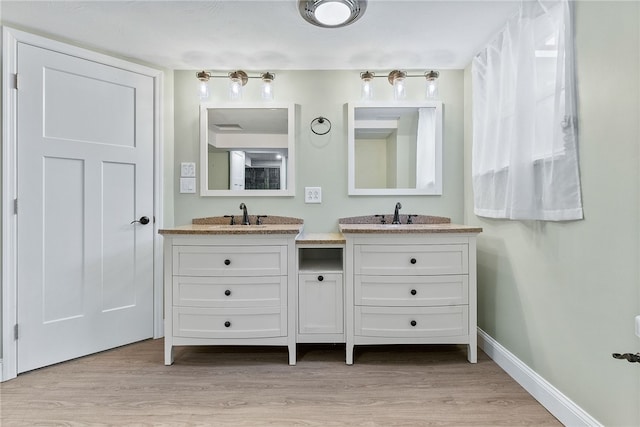 bathroom with vanity and hardwood / wood-style flooring