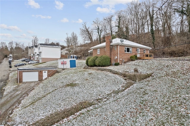 view of home's exterior with a garage and a wooden deck