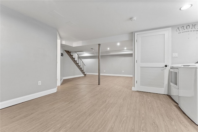 basement featuring washer and clothes dryer and light hardwood / wood-style flooring