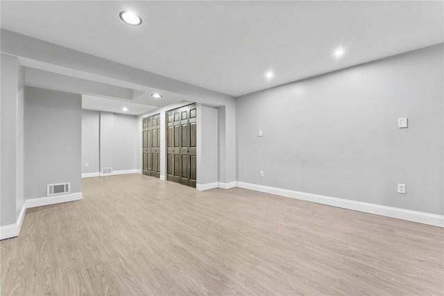 basement with light hardwood / wood-style floors