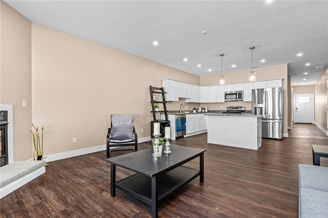 living room with dark hardwood / wood-style floors and sink