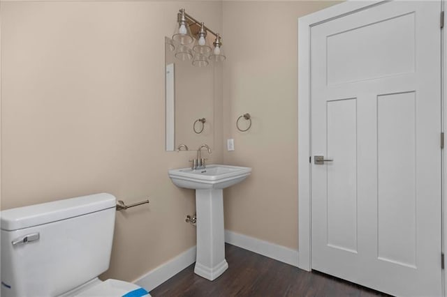 bathroom with hardwood / wood-style floors and toilet