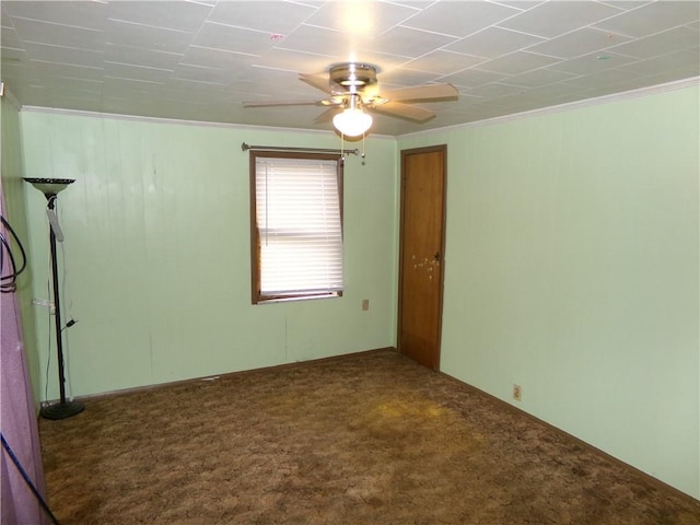 carpeted spare room featuring ceiling fan and ornamental molding