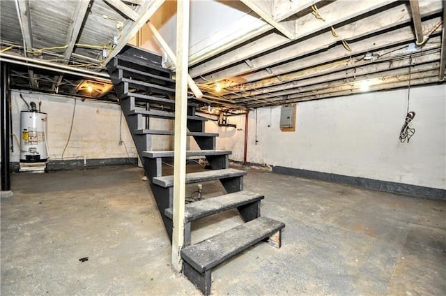 basement featuring electric panel and water heater