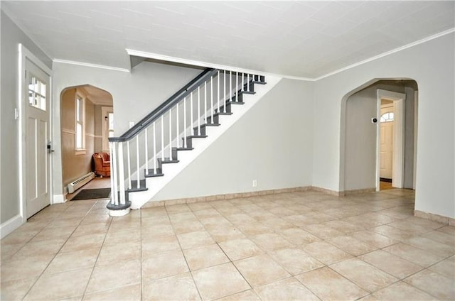 entrance foyer featuring a baseboard heating unit, light tile patterned floors, and crown molding