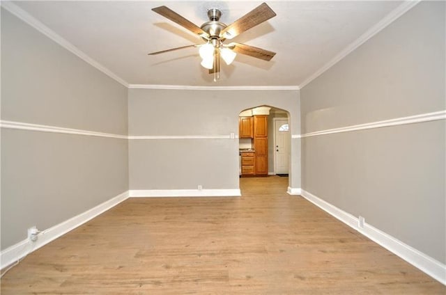 spare room with ceiling fan, light hardwood / wood-style floors, and crown molding