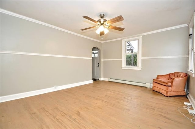 unfurnished room featuring light hardwood / wood-style flooring, baseboard heating, crown molding, and ceiling fan