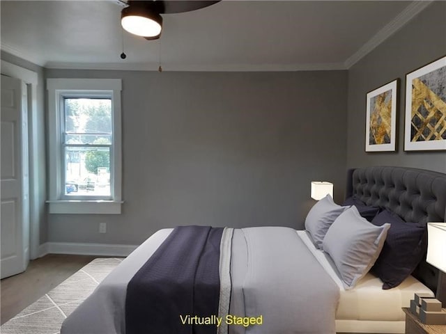 bedroom featuring hardwood / wood-style floors, ceiling fan, and crown molding