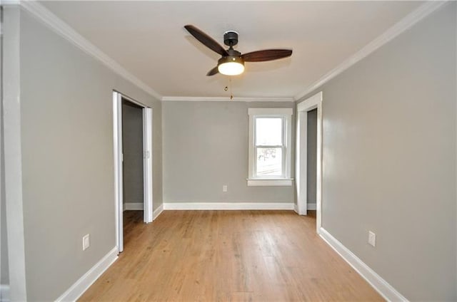 unfurnished bedroom with ceiling fan, light wood-type flooring, crown molding, and a closet