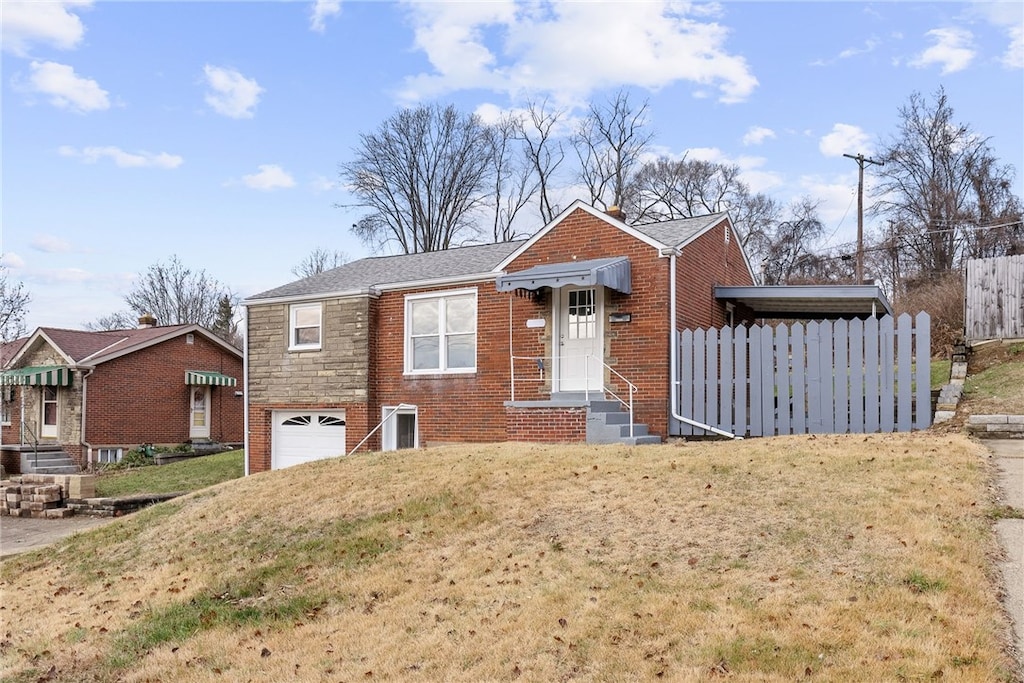 view of front of property with a front lawn and a garage