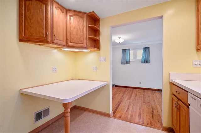 kitchen featuring light hardwood / wood-style flooring, white dishwasher, and ornamental molding