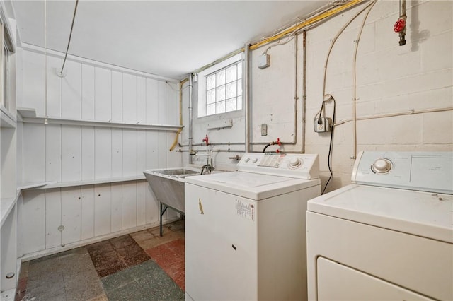 laundry room with washing machine and clothes dryer and sink