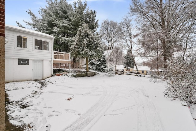 snowy yard featuring a deck