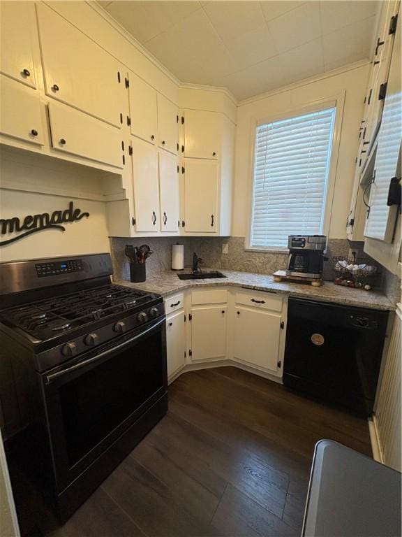 kitchen with black appliances, white cabinets, sink, dark hardwood / wood-style floors, and light stone counters