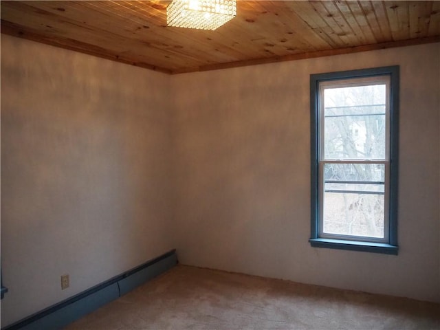 carpeted spare room with baseboard heating and wooden ceiling