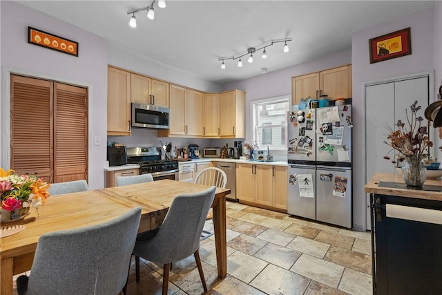 kitchen with light brown cabinets, stainless steel appliances, and sink