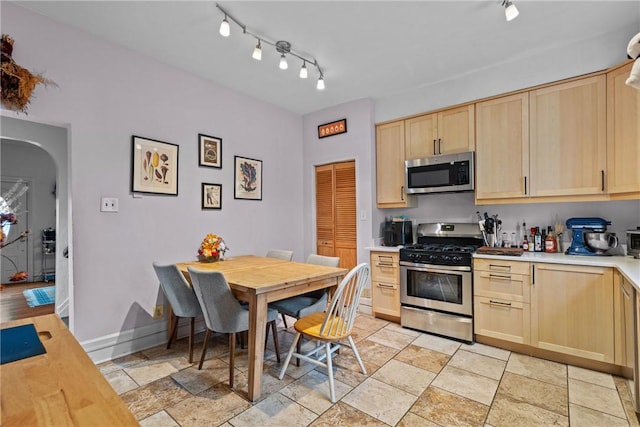 kitchen with stainless steel appliances and light brown cabinetry