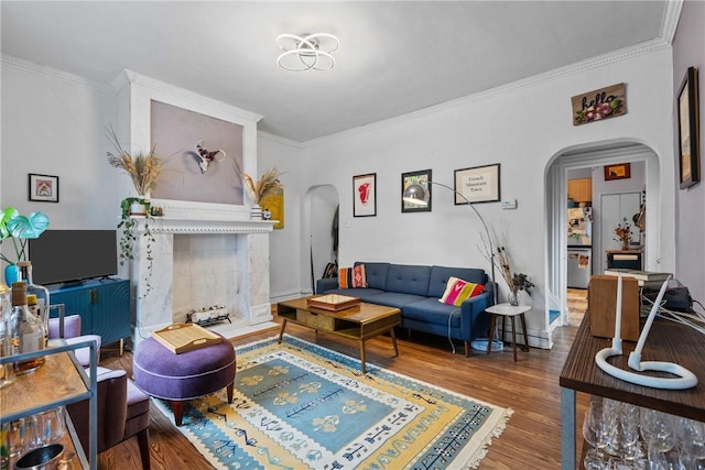 living room with crown molding and hardwood / wood-style floors