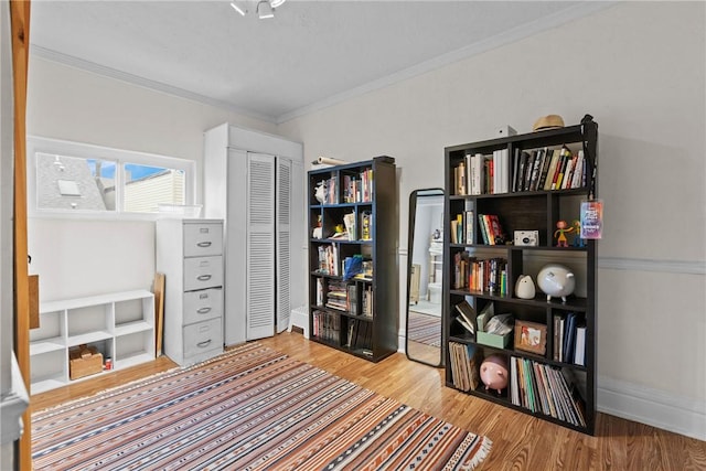 interior space featuring light hardwood / wood-style floors and crown molding