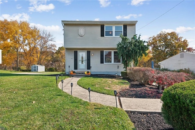 view of front property with a front lawn and a storage shed