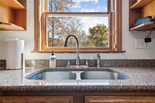 details featuring sink and stone counters