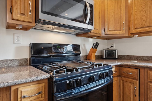 kitchen with black gas range oven