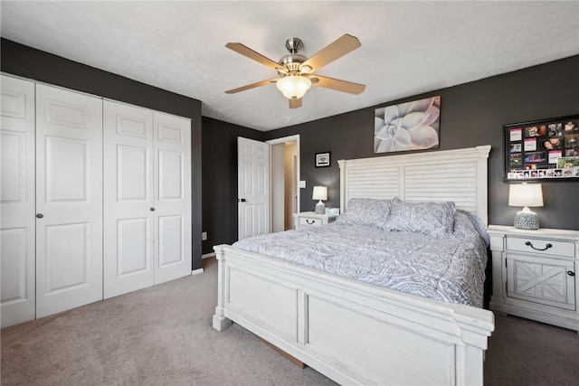 carpeted bedroom featuring ceiling fan and a closet