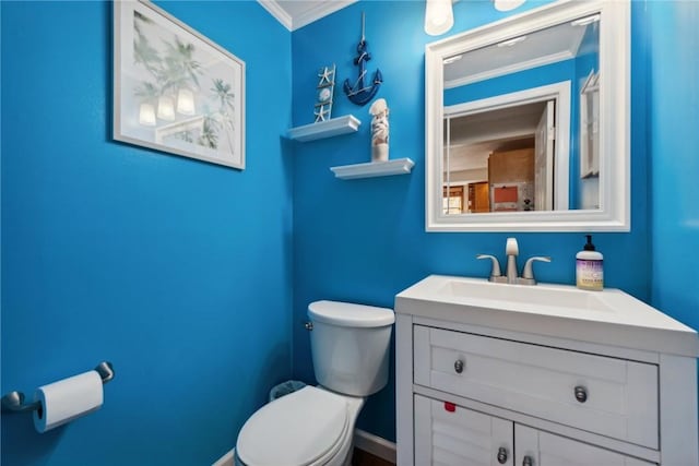 bathroom featuring vanity, toilet, and ornamental molding