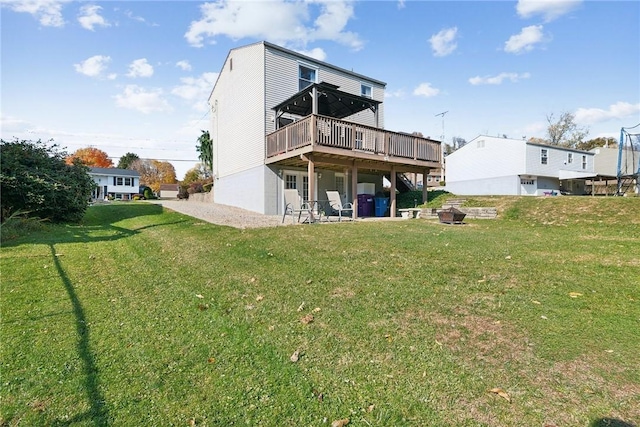 back of house featuring a lawn and a wooden deck