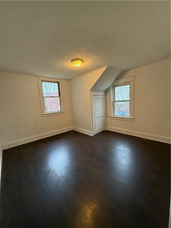 bonus room featuring dark hardwood / wood-style floors