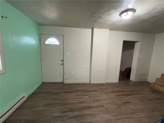 foyer entrance featuring dark hardwood / wood-style flooring and a baseboard heating unit