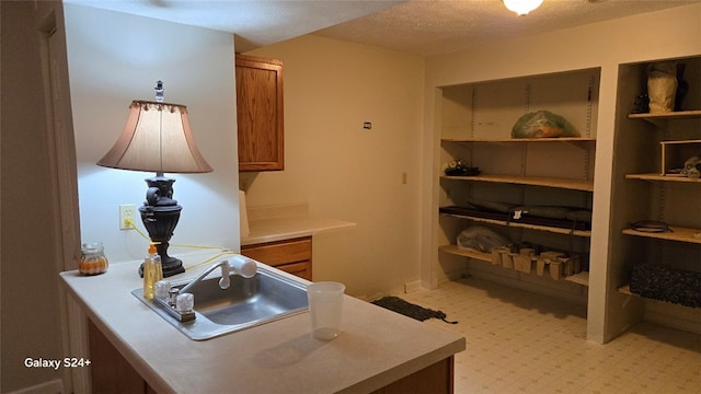 kitchen featuring sink and a textured ceiling