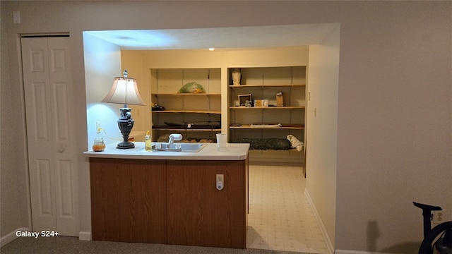 office area with built in shelves and sink