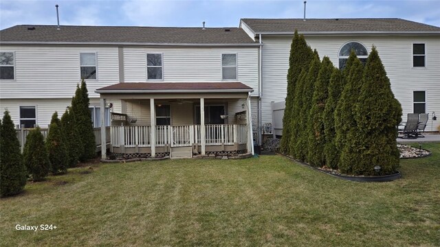 view of front of property with a deck and a front lawn