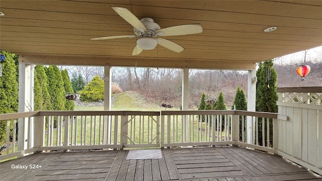 wooden deck featuring ceiling fan