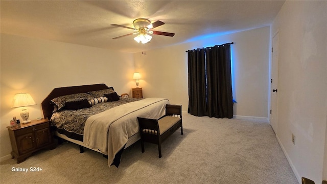 bedroom with ceiling fan and light colored carpet