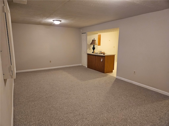 unfurnished room with carpet floors and a textured ceiling