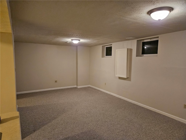 basement with a textured ceiling and carpet