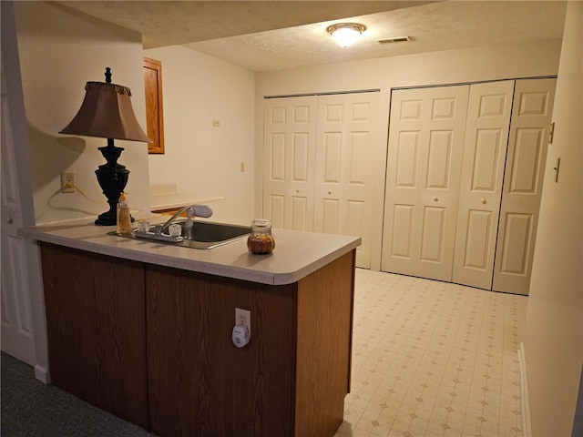 office area featuring sink and a textured ceiling